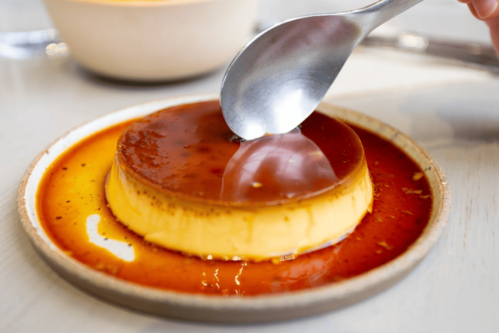 Perfect banh flan with golden caramel sauce flowing down the sides of the silky custard (Source: Pexels)